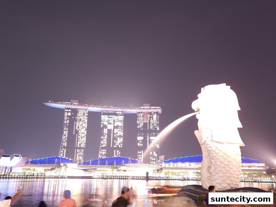 Night view of the Merlion statue with Marina Bay Sands in the background.