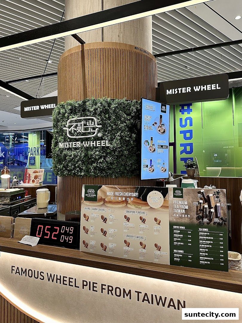 A counter display for Mister Wheel Singapore, showcasing wheel pies and premium teas from Taiwan.
