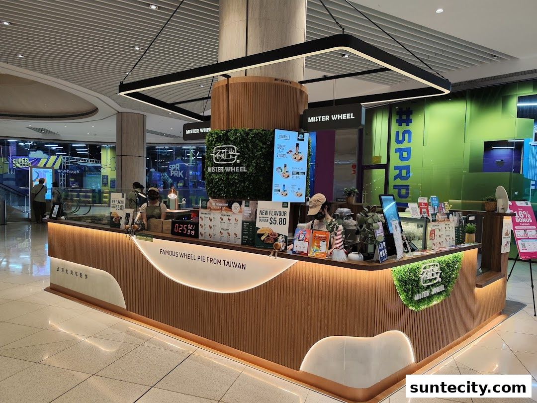 A Mister Wheel shop counter selling Taiwanese wheel pies with a green wall and menu displays.