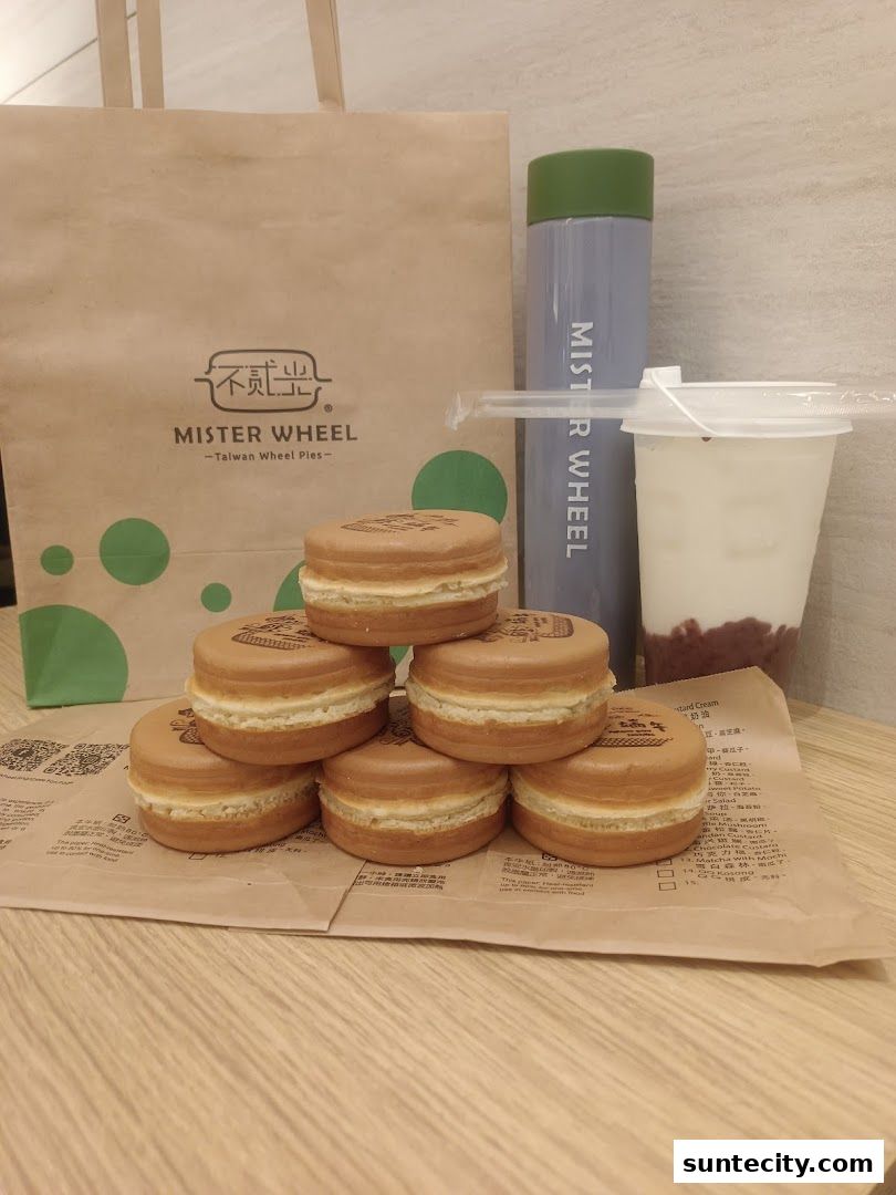 A collection of Taiwan Wheel Pies, a drink, and a branded bag from Mister Wheel.