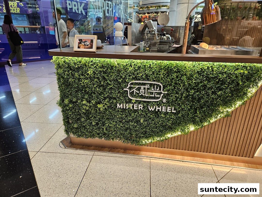 The Mister Wheel Singapore shop front features a green, leafy facade with the shop's logo.