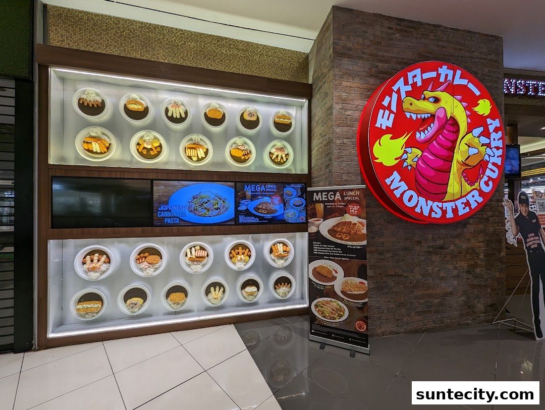 Monster Curry shop front with a large circular sign and display of food models.