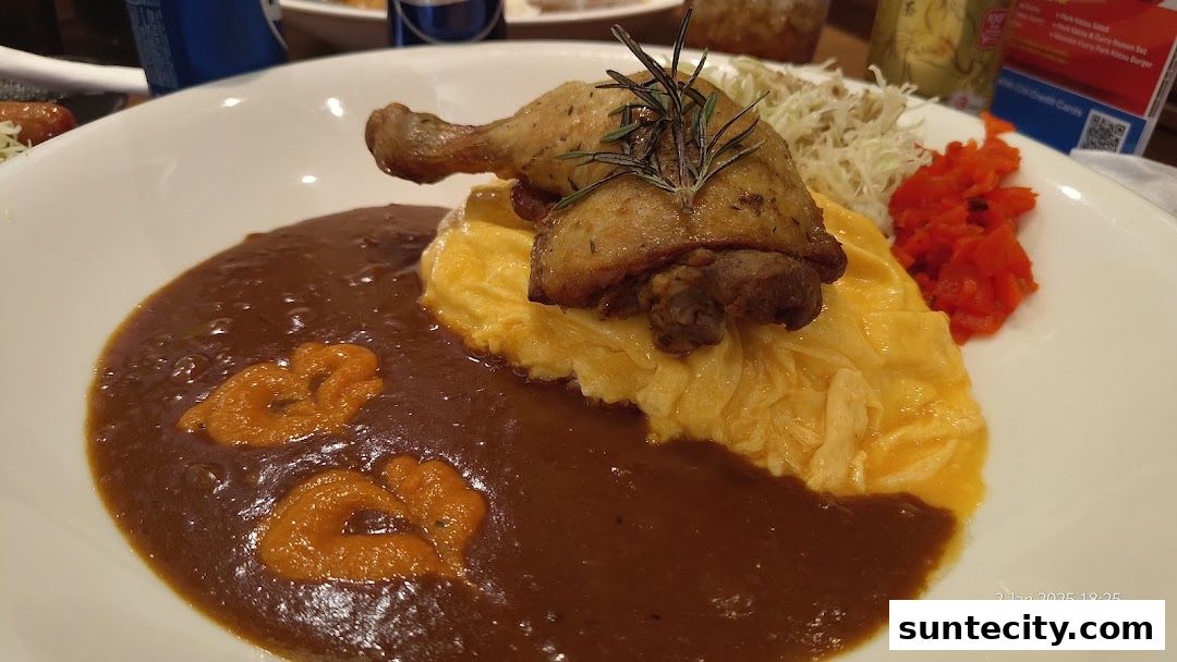 A delicious plate of Japanese curry with a crispy chicken leg and omelette.