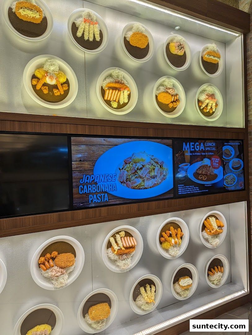 Display of various Japanese curry dishes with different toppings and a pasta dish.