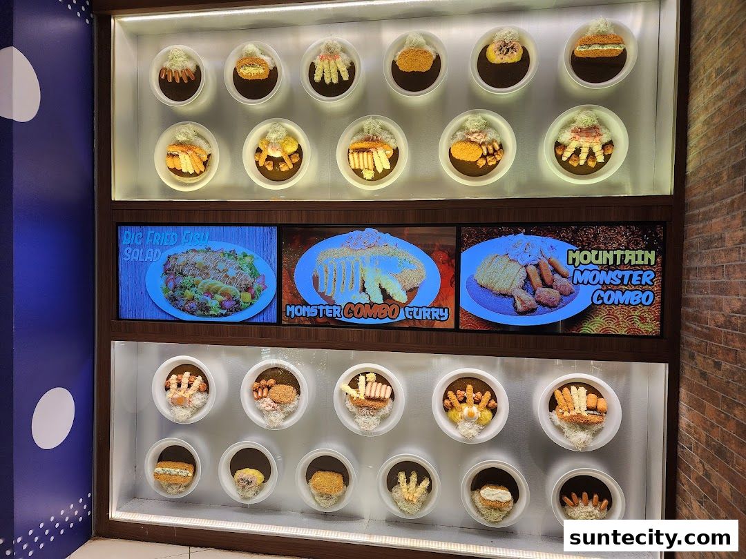A display case showcasing various curry dishes and combos from Monster Curry.