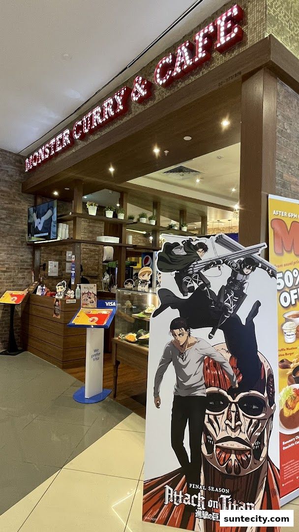 Monster Curry & Cafe storefront with Attack on Titan promotional display.