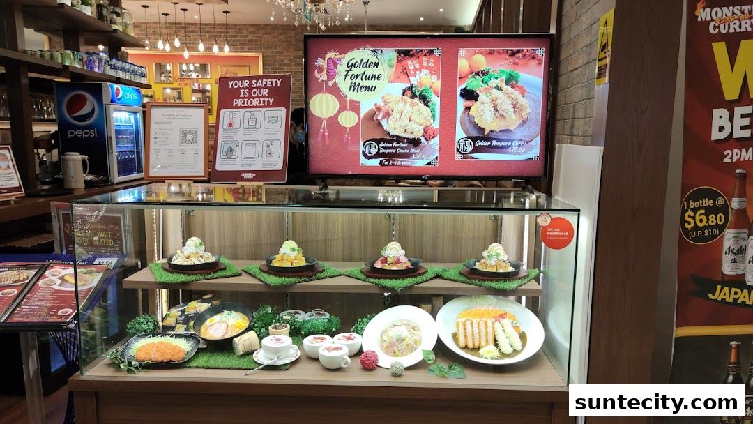 Monster Curry shop display featuring food models and a digital menu board.