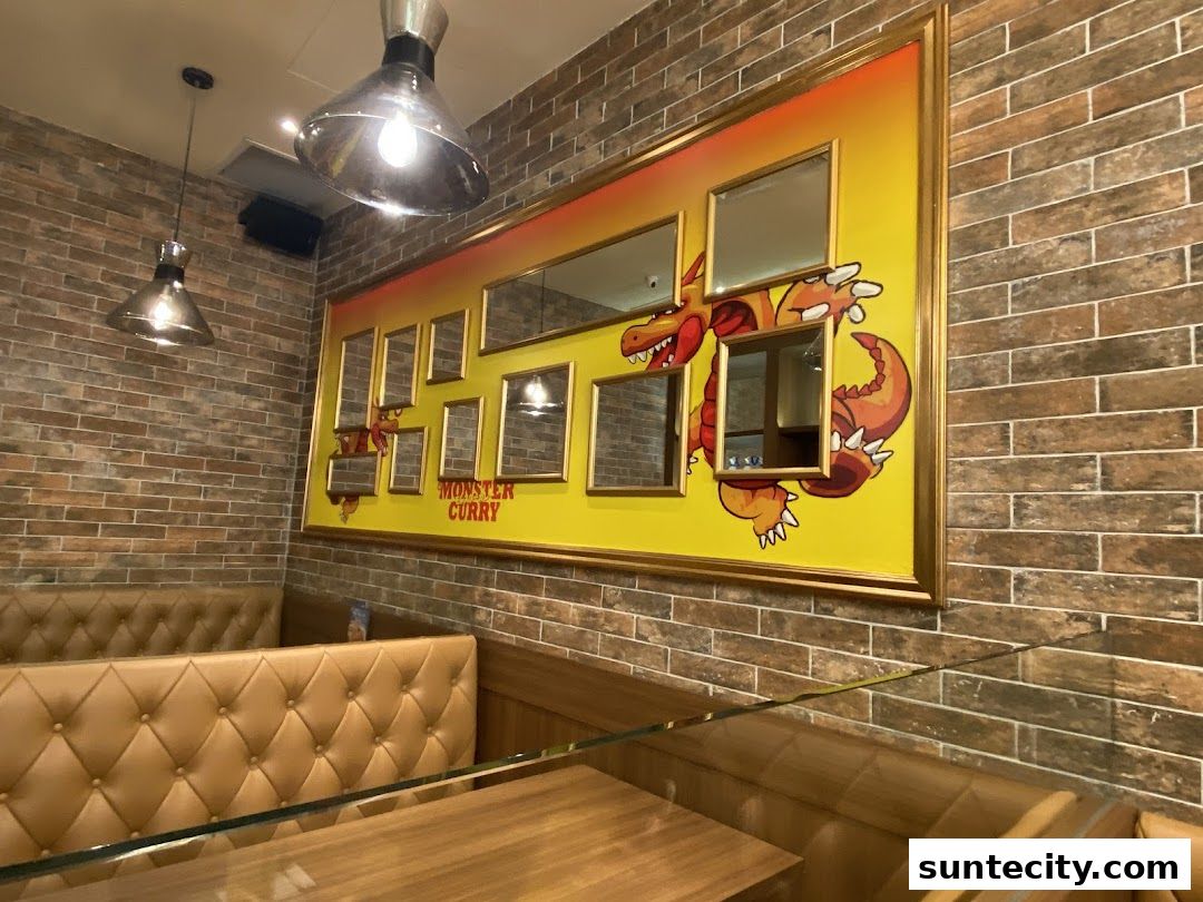 Interior shot of Monster Curry restaurant with brick walls and booth seating.