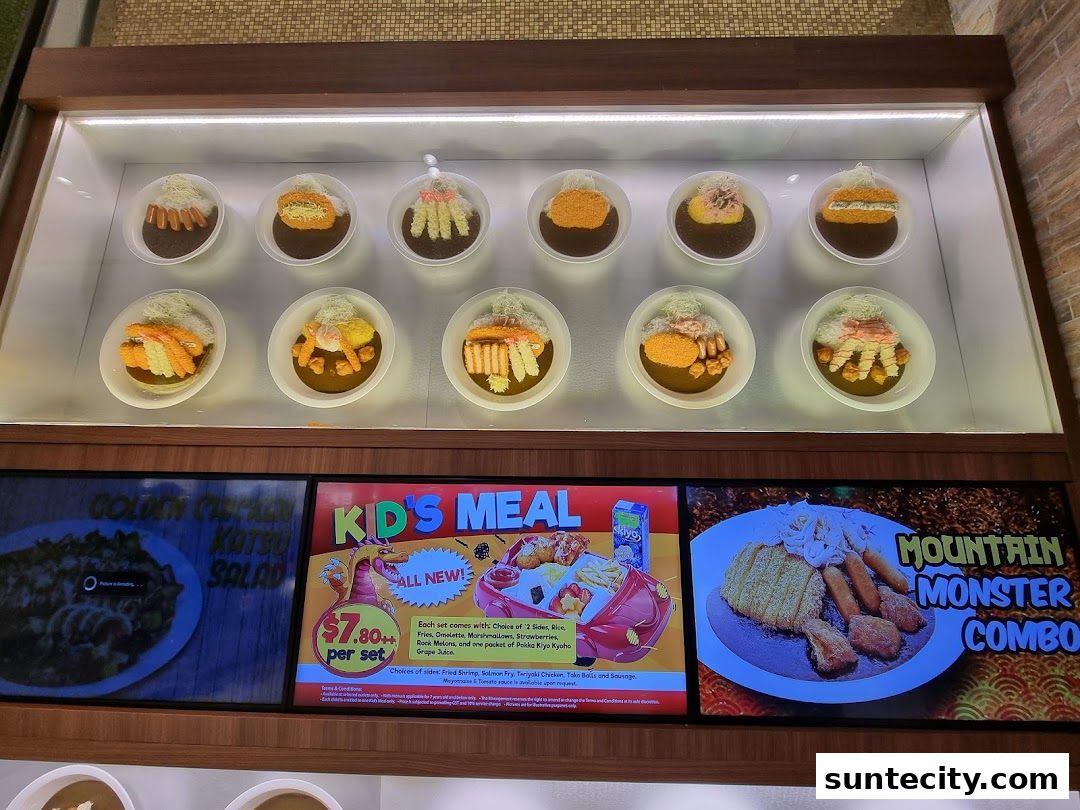 Display of various curry dishes and promotional signs for a restaurant.