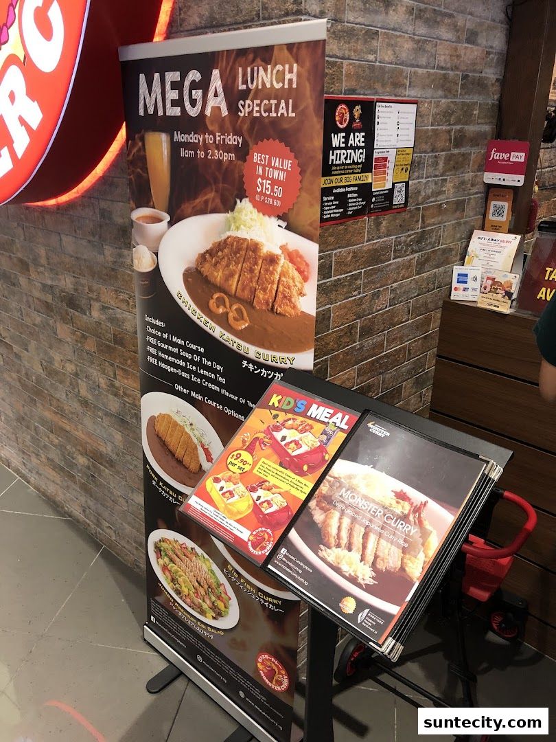 A promotional stand for Monster Curry featuring a lunch special and kids' meal.