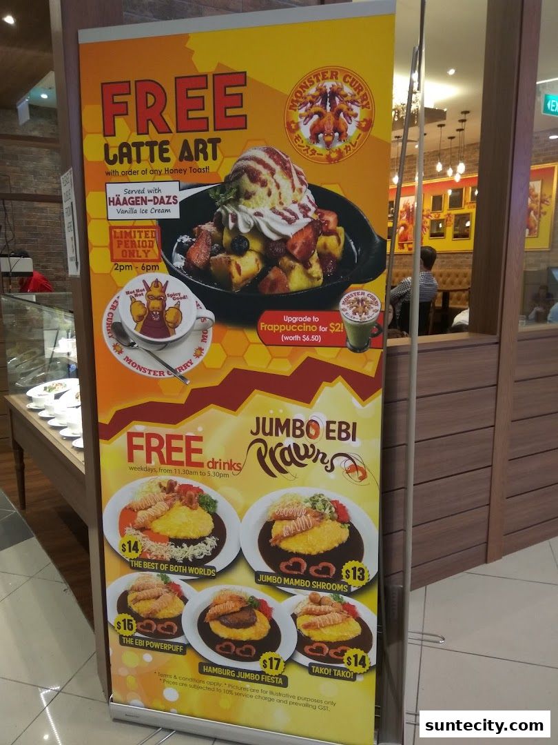 A promotional banner for Monster Curry featuring free latte art and jumbo ebi prawn dishes.