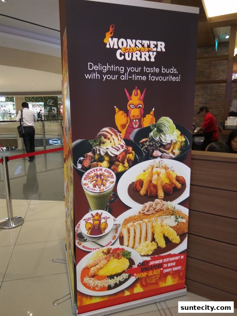 A banner for Monster Curry featuring various curry dishes and drinks with a cartoon monster mascot.