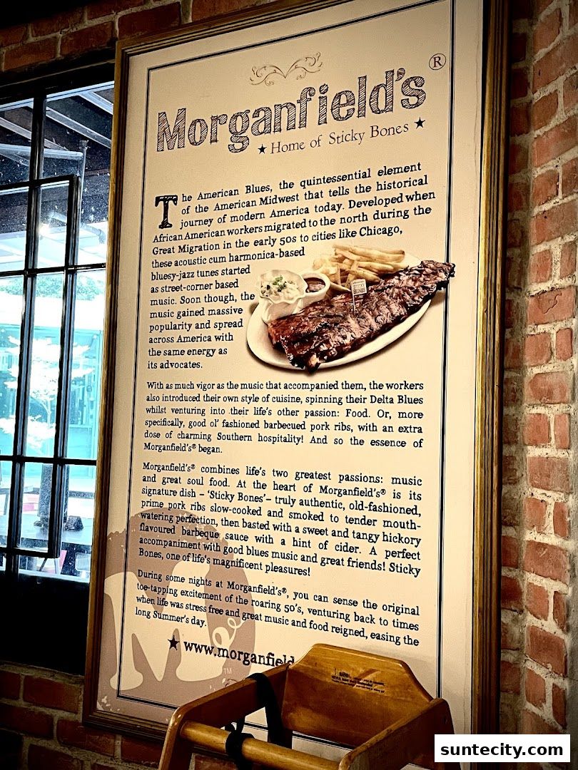 A framed poster about Morganfield's restaurant, featuring a picture of ribs and text about its history.