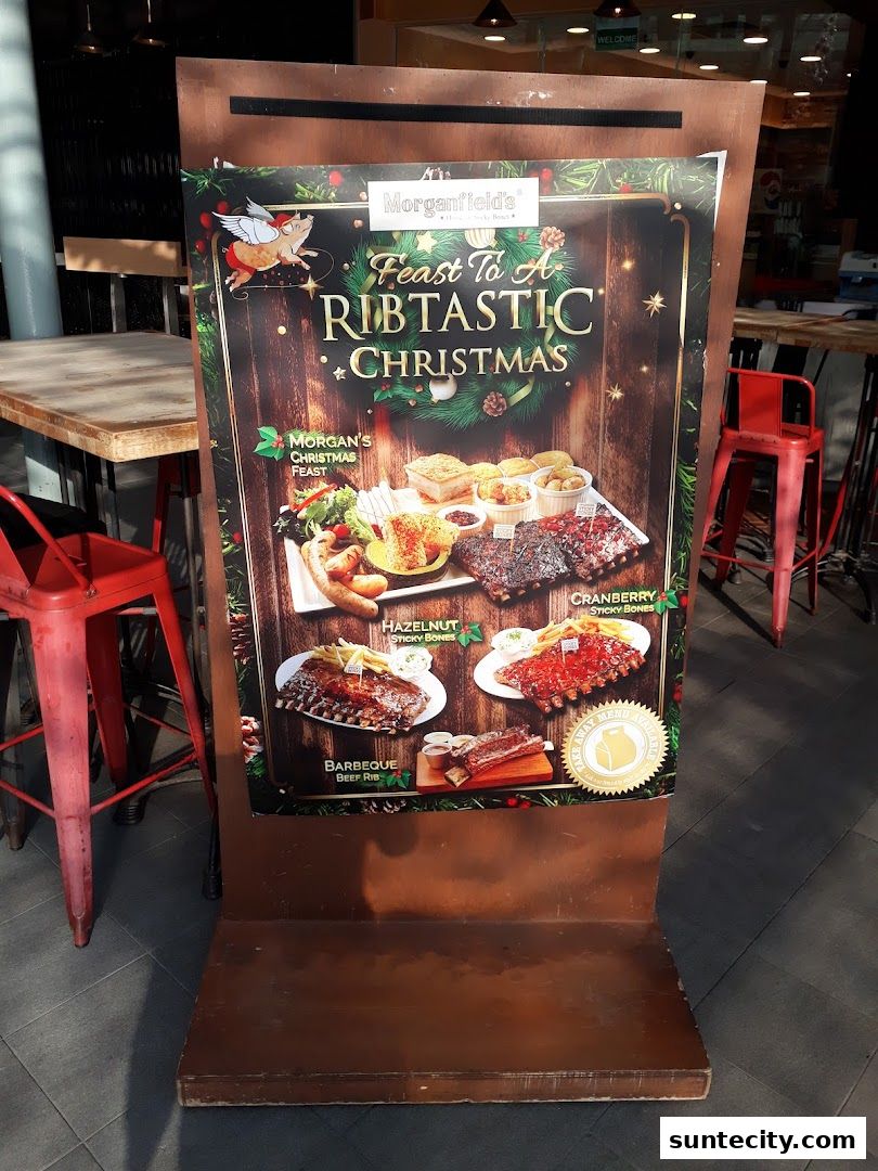 A promotional sign for Morganfield's Christmas feast featuring various rib dishes.