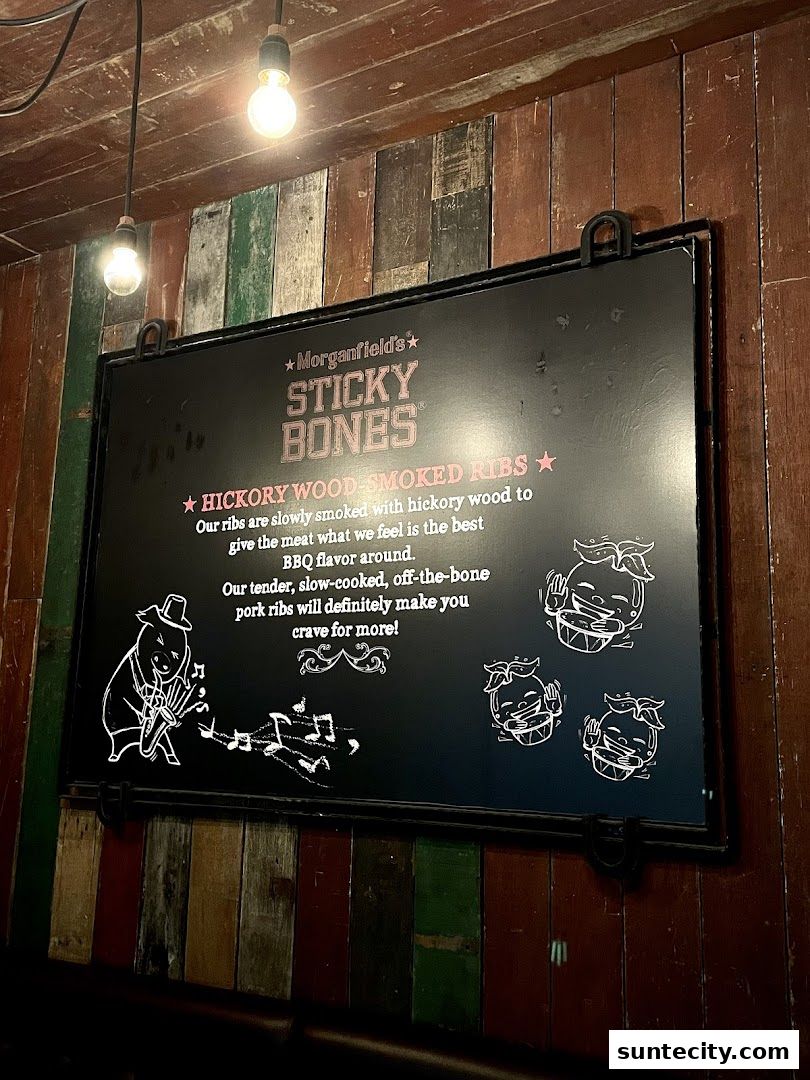 A sign advertising Morganfield's Sticky Bones Hickory Wood-Smoked Ribs.