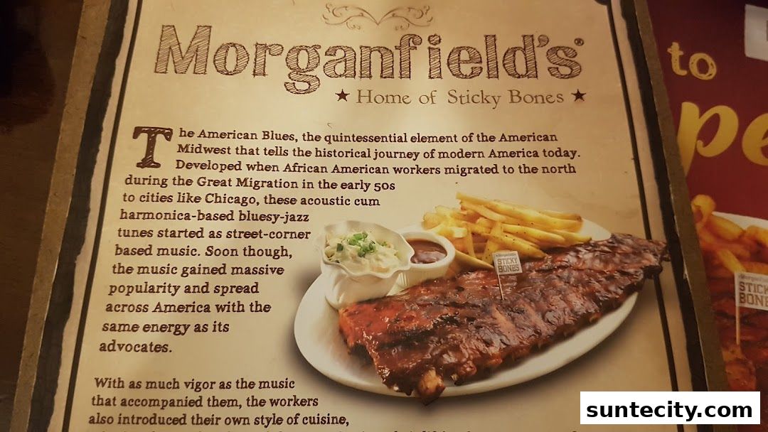 A close-up of a menu featuring a rack of ribs with fries and coleslaw.