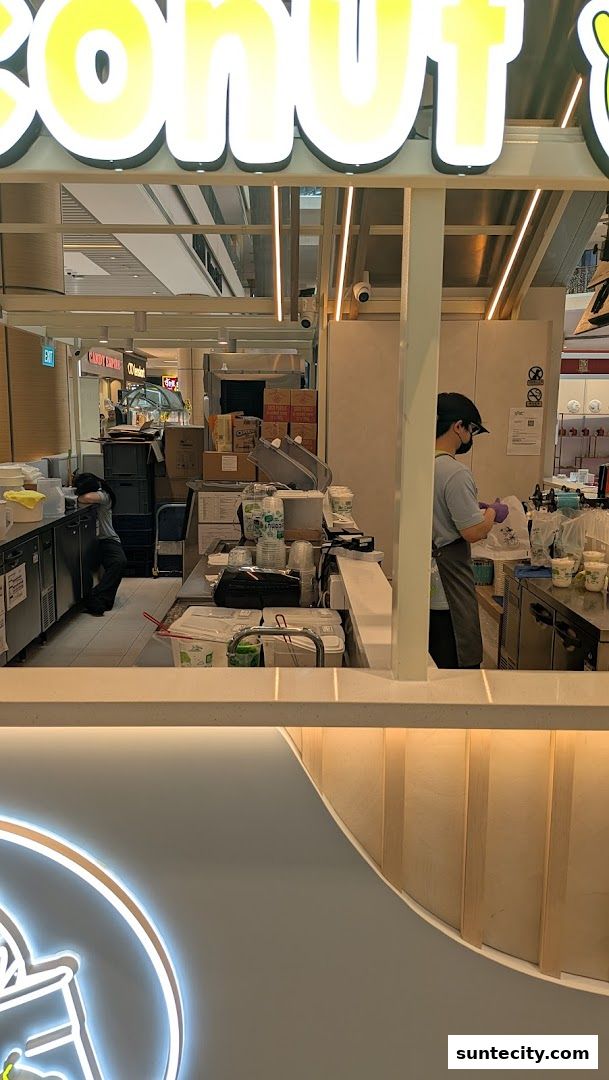 Staff preparing drinks behind the counter at Mr. Coconut Suntec City.