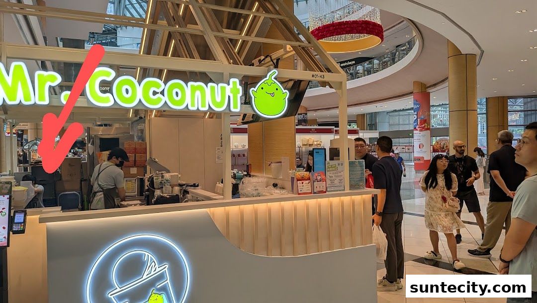 Mr. Coconut shop front with staff preparing drinks and customers nearby in a mall.
