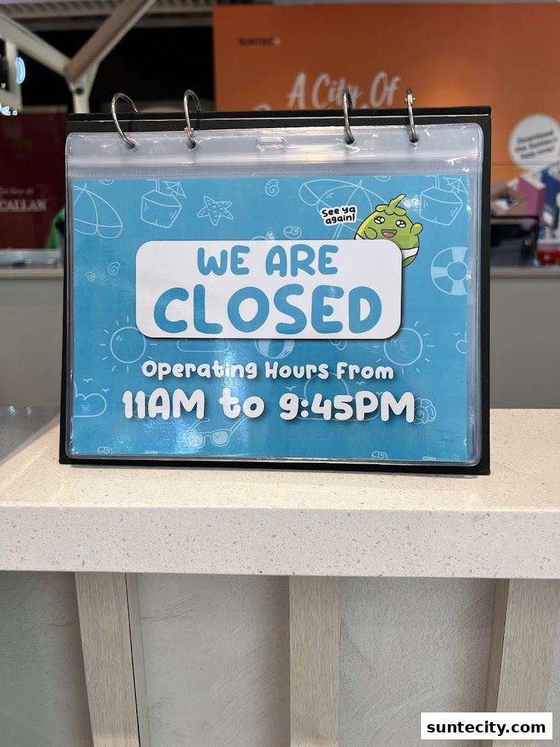A sign indicating that Mr. Coconut Suntec City is closed with operating hours from 11 AM to 9:45 PM.