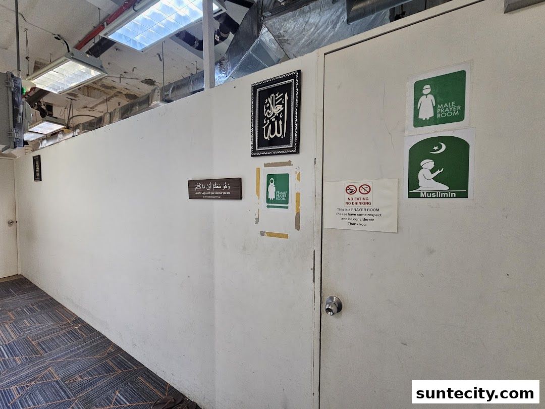 A hallway with signs indicating separate prayer rooms for males and females.