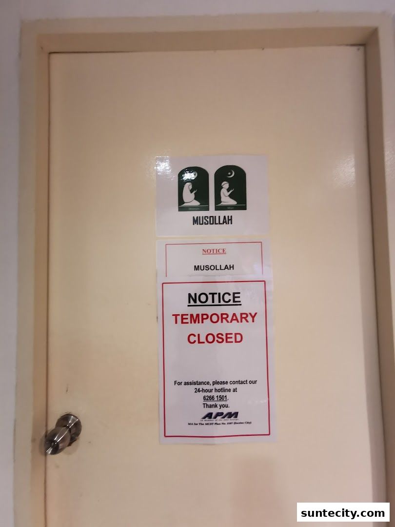 A door with signs indicating the Musollah is temporarily closed.