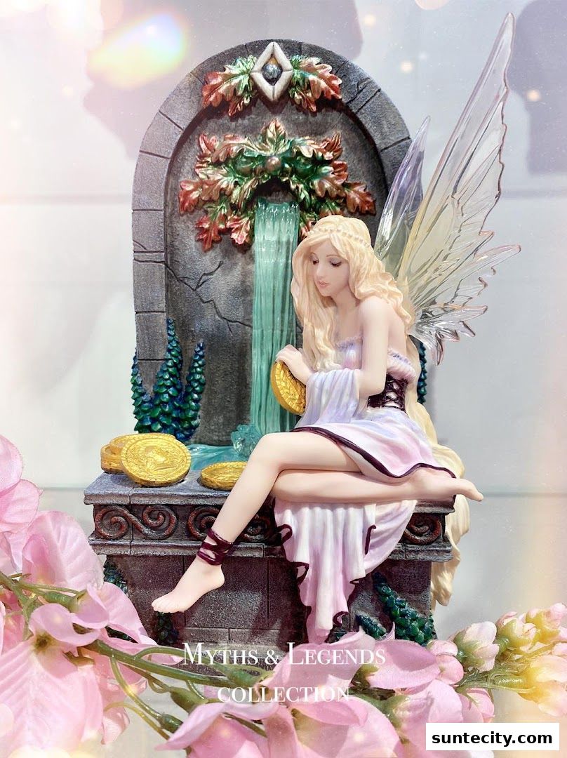 A fairy figurine sits by a waterfall with gold coins, surrounded by flowers.