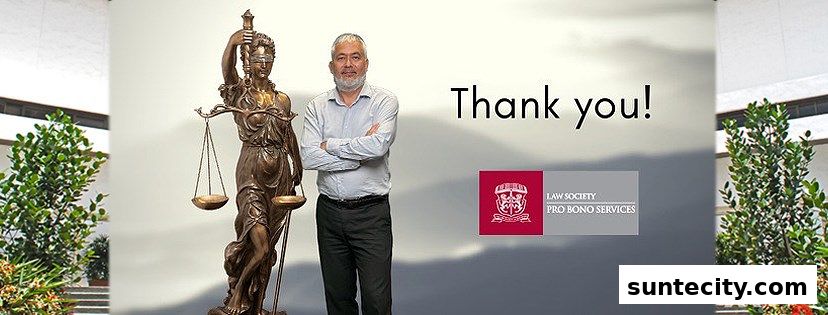 A man stands next to a statue of Lady Justice, with the Law Society Pro Bono Services logo.