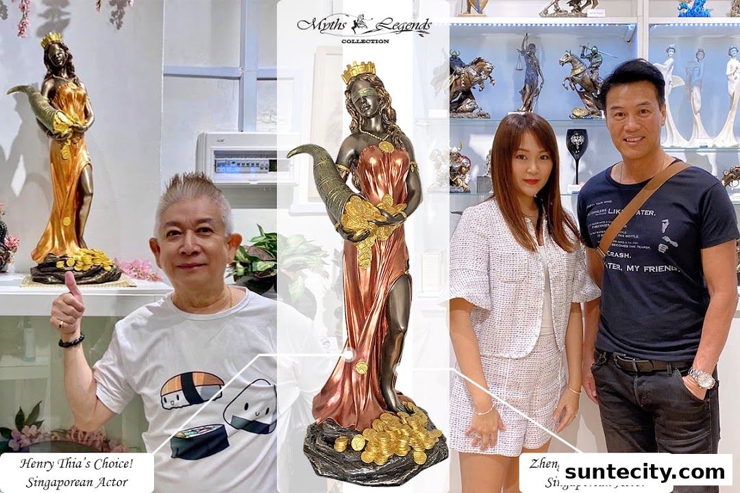 Two Singaporean actors posing with decorative statues in a shop.