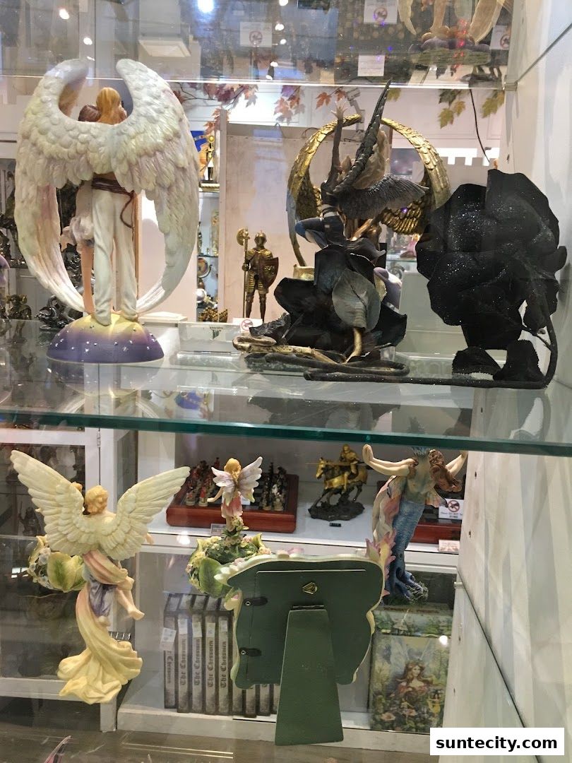 A display window showcasing various mythical and fantasy-themed figurines, including angels and mermaids.