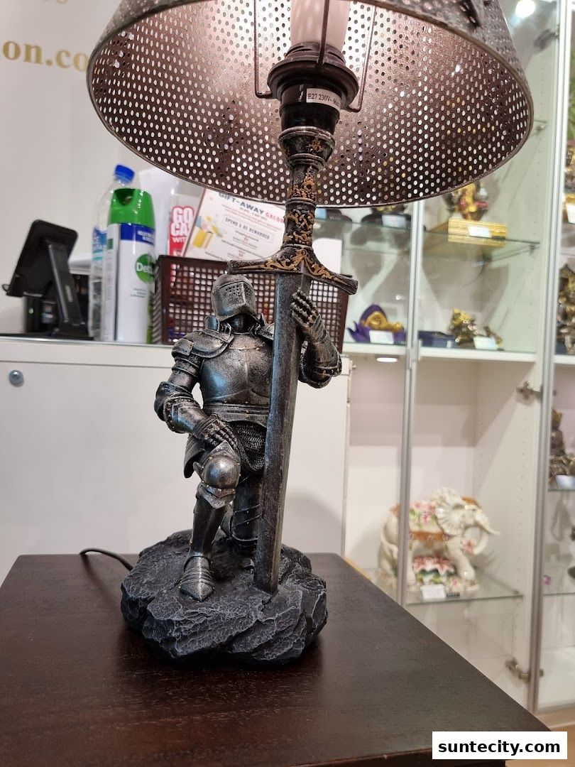 A knight statue holding a sword as a lamp base, with display cabinets in the background.