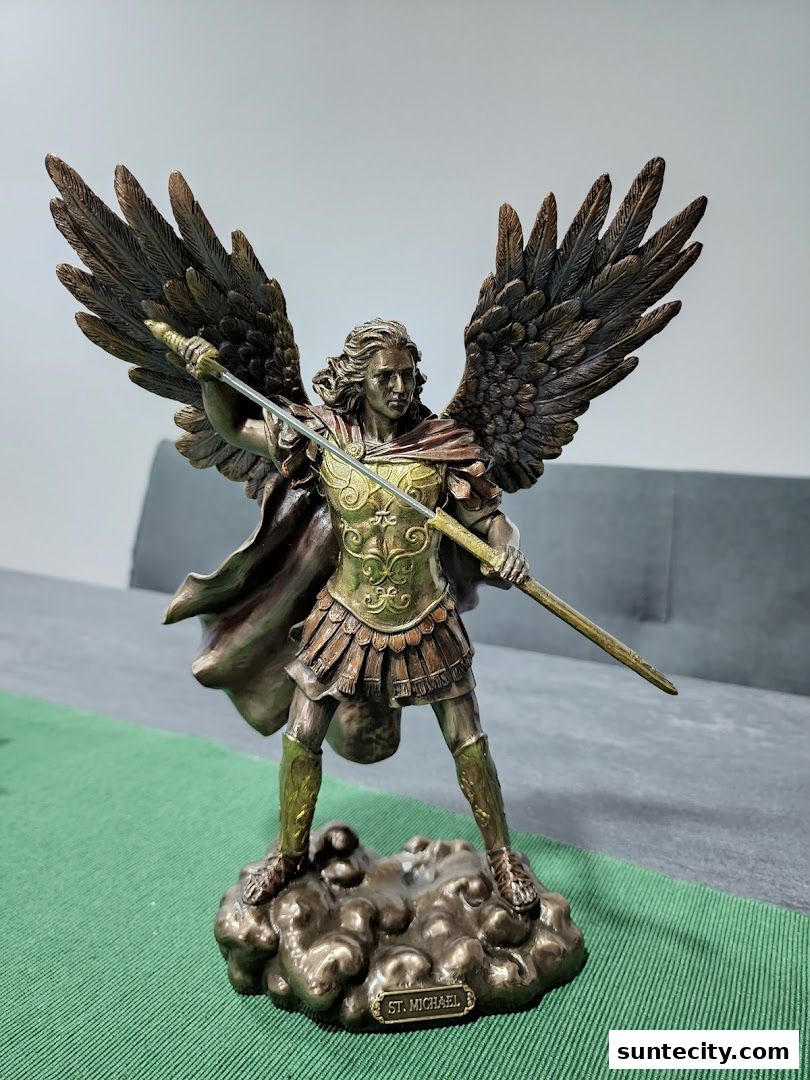A detailed statue of Saint Michael the Archangel holding a spear.