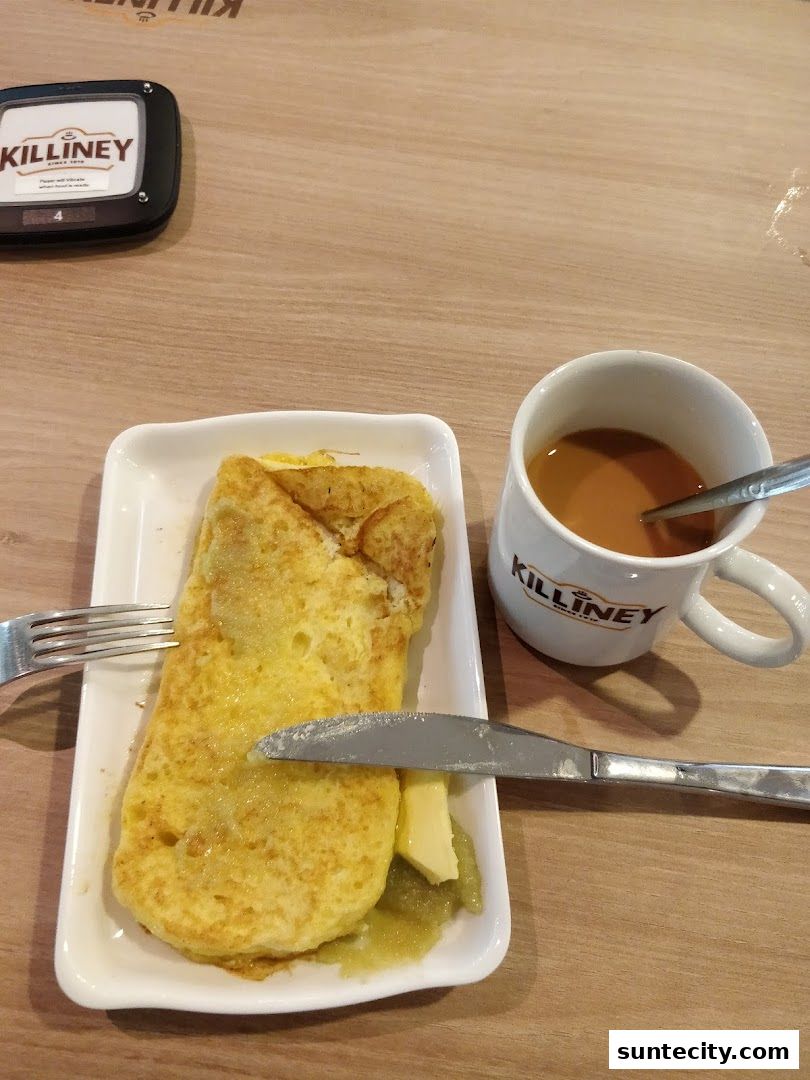 A plate of French toast with butter and a cup of coffee from Killiney.