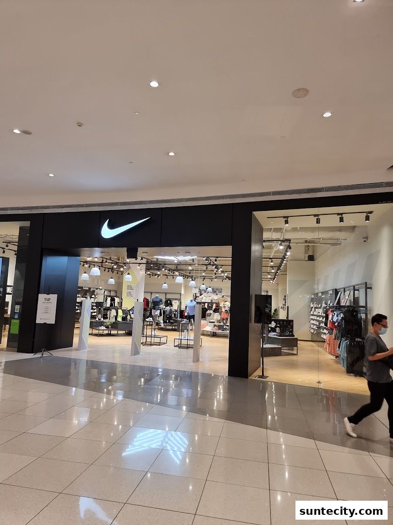 The entrance to a brightly lit Nike store showcasing athletic apparel and footwear.