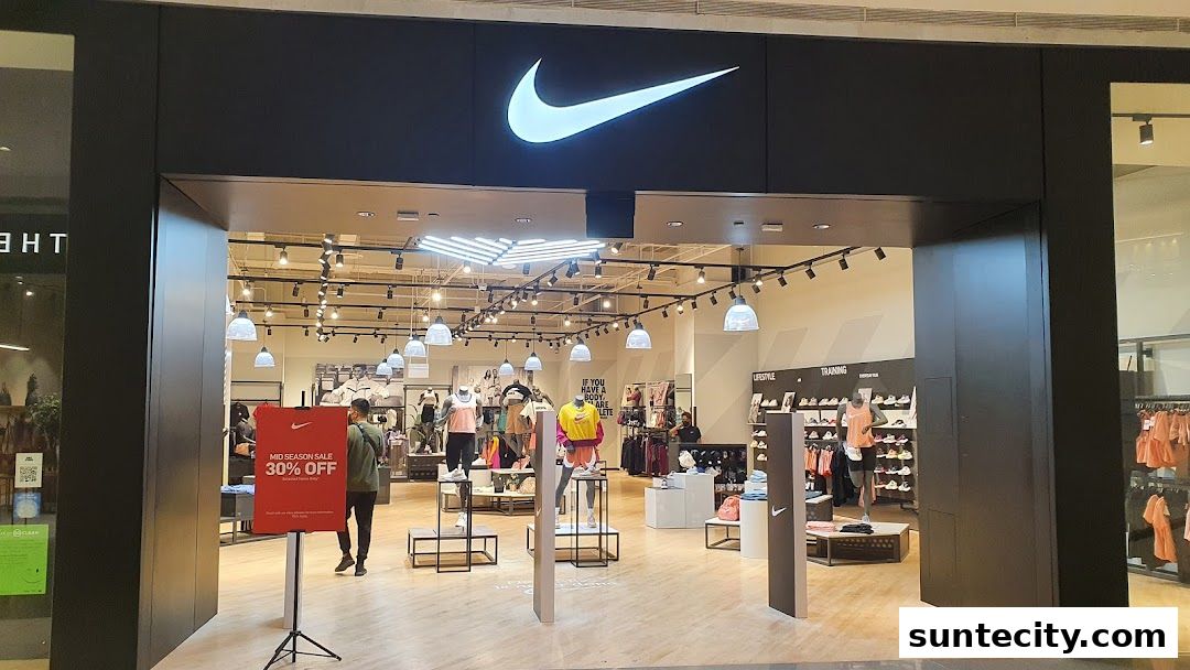 The entrance of a Nike store with the iconic logo and a mid-season sale sign.