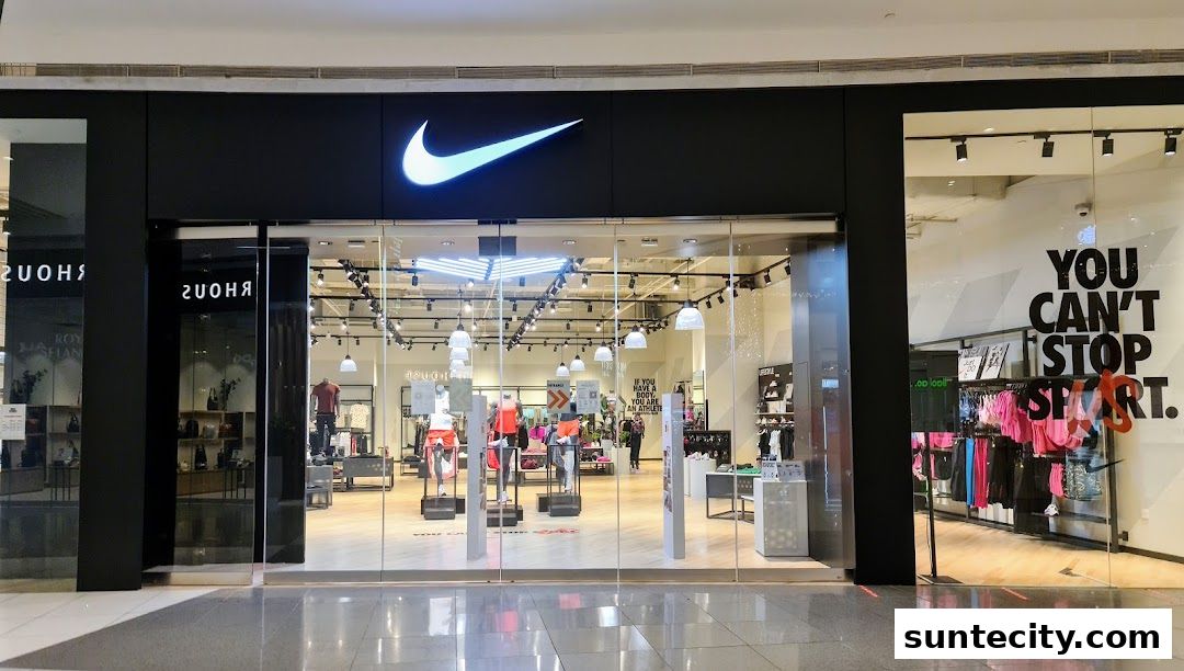 The exterior of a Nike store with its iconic logo and a display of athletic apparel.