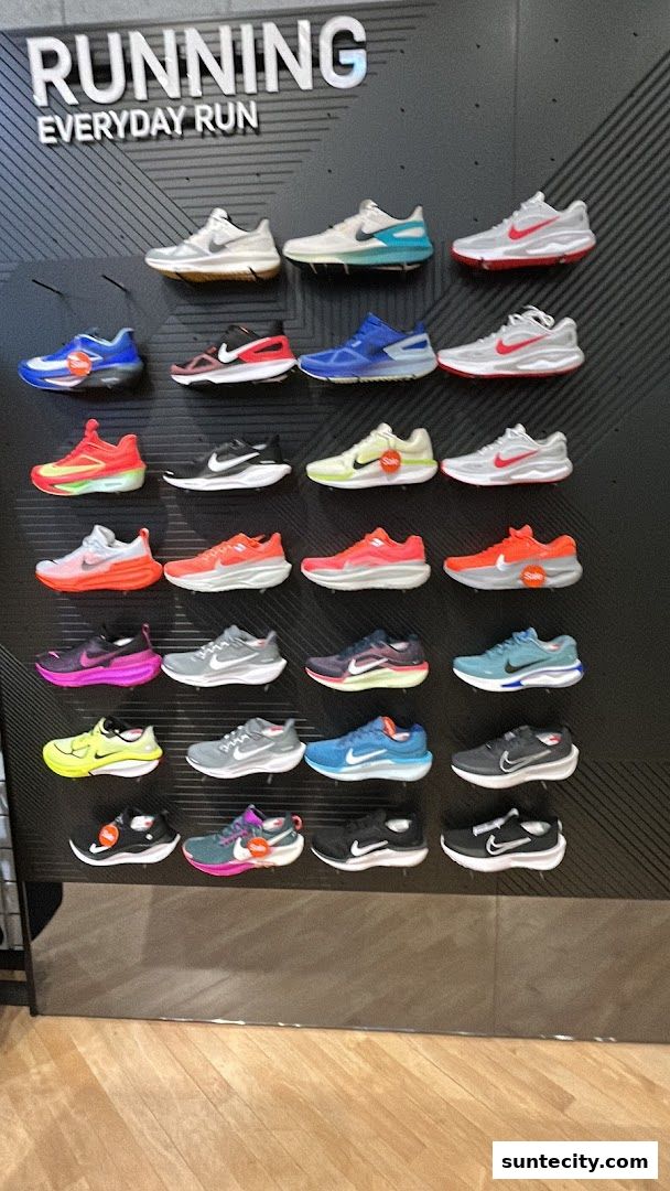 A wall display showcasing various Nike running shoes in different colors and styles.