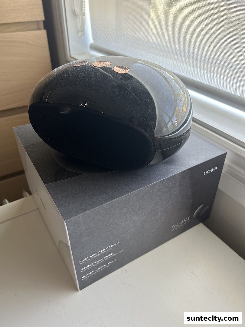 A black Ogawa G-Lover massage device sits on its branded box.