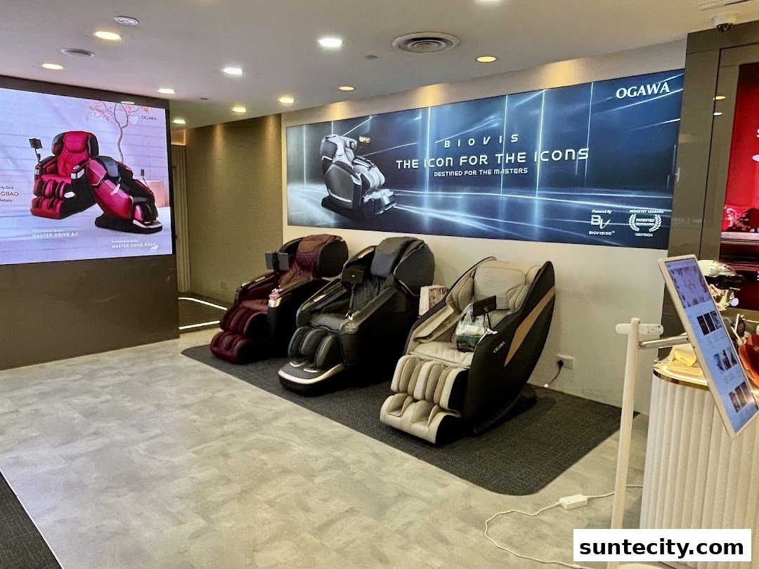 Interior view of an Ogawa store showcasing several massage chairs and digital displays.