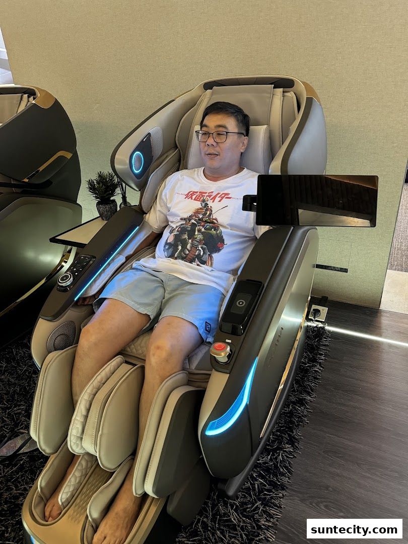 A man sits in a modern massage chair, experiencing its features.