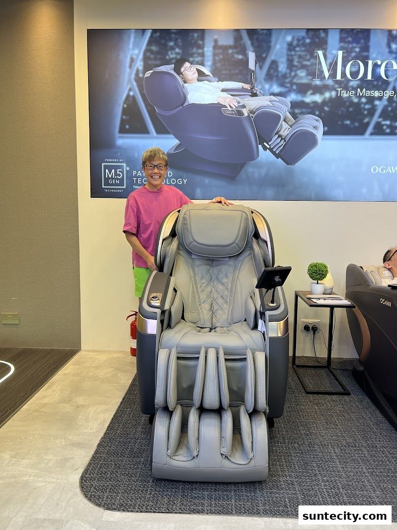 A person stands next to a luxurious massage chair in a retail store.