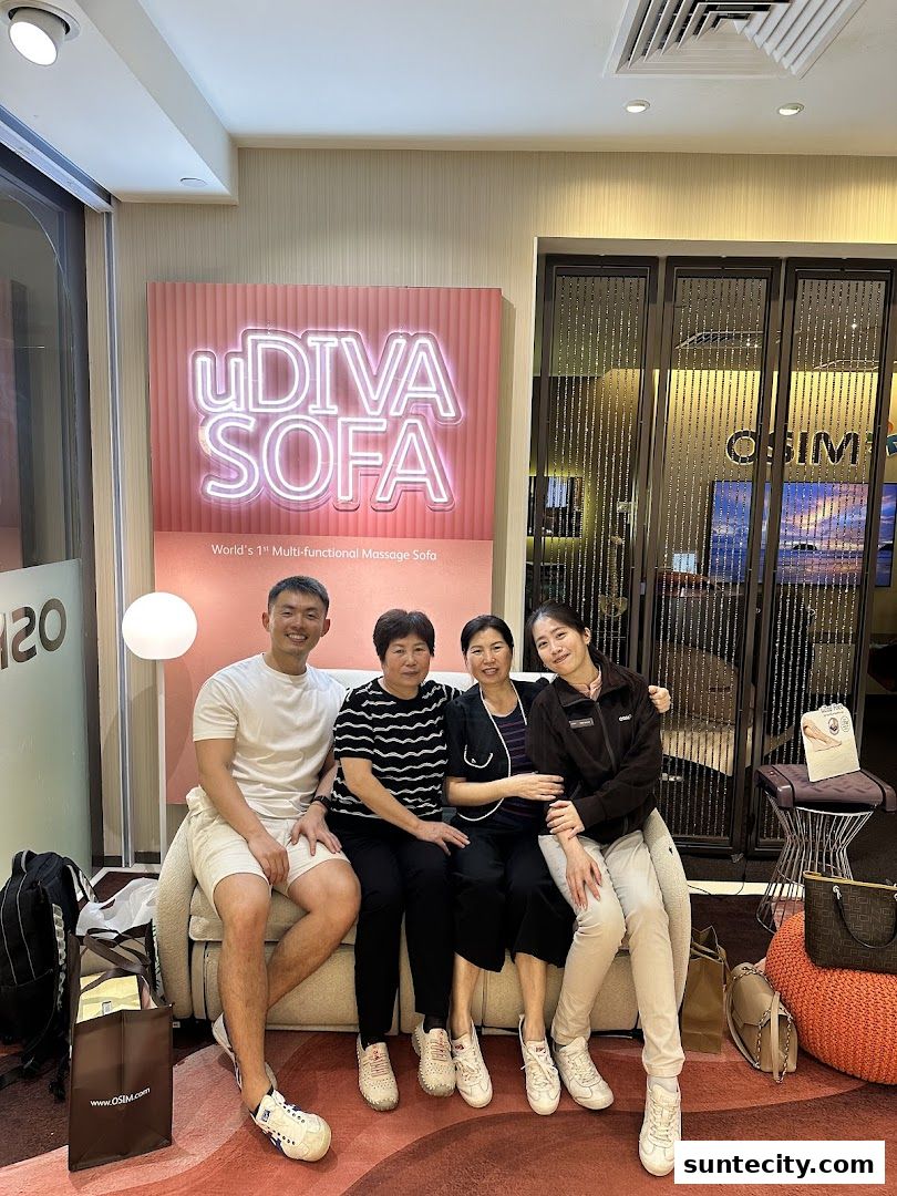 A family poses for a photo on a massage sofa in an OSIM store.