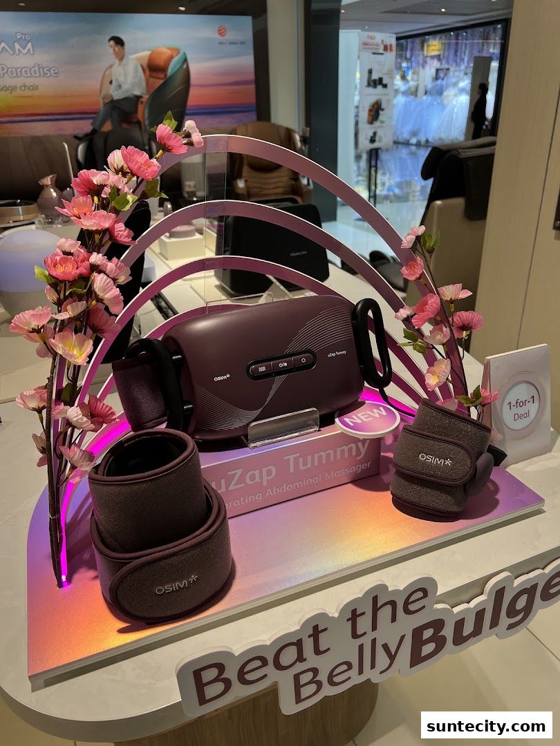 OSIM uZap Tummy abdominal massager displayed with floral decorations and a 1-for-1 deal.