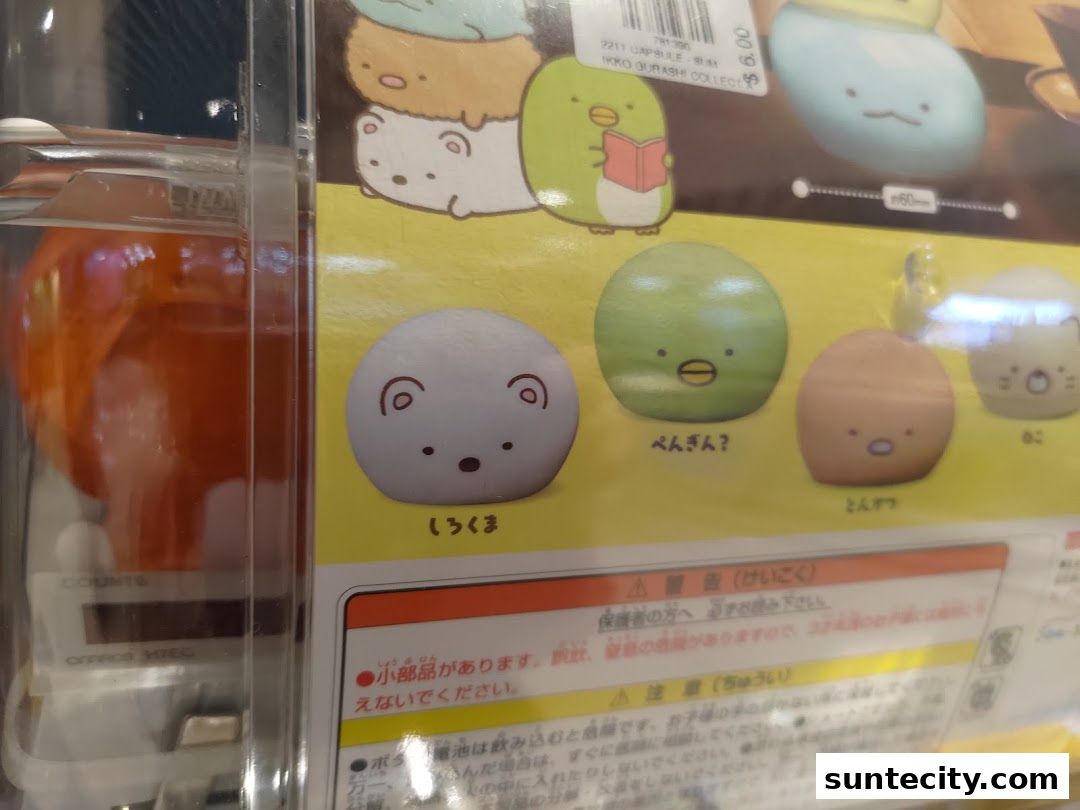 A display of cute, round, character-themed collectible toys, likely from a gachapon machine.
