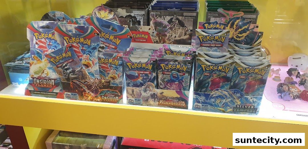 Display of various Pokemon trading card game booster packs and small figurines.