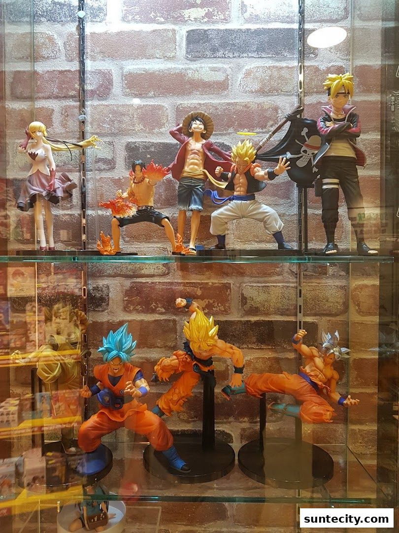 Display case filled with anime action figures, featuring characters from popular series like Dragon Ball and One Piece.