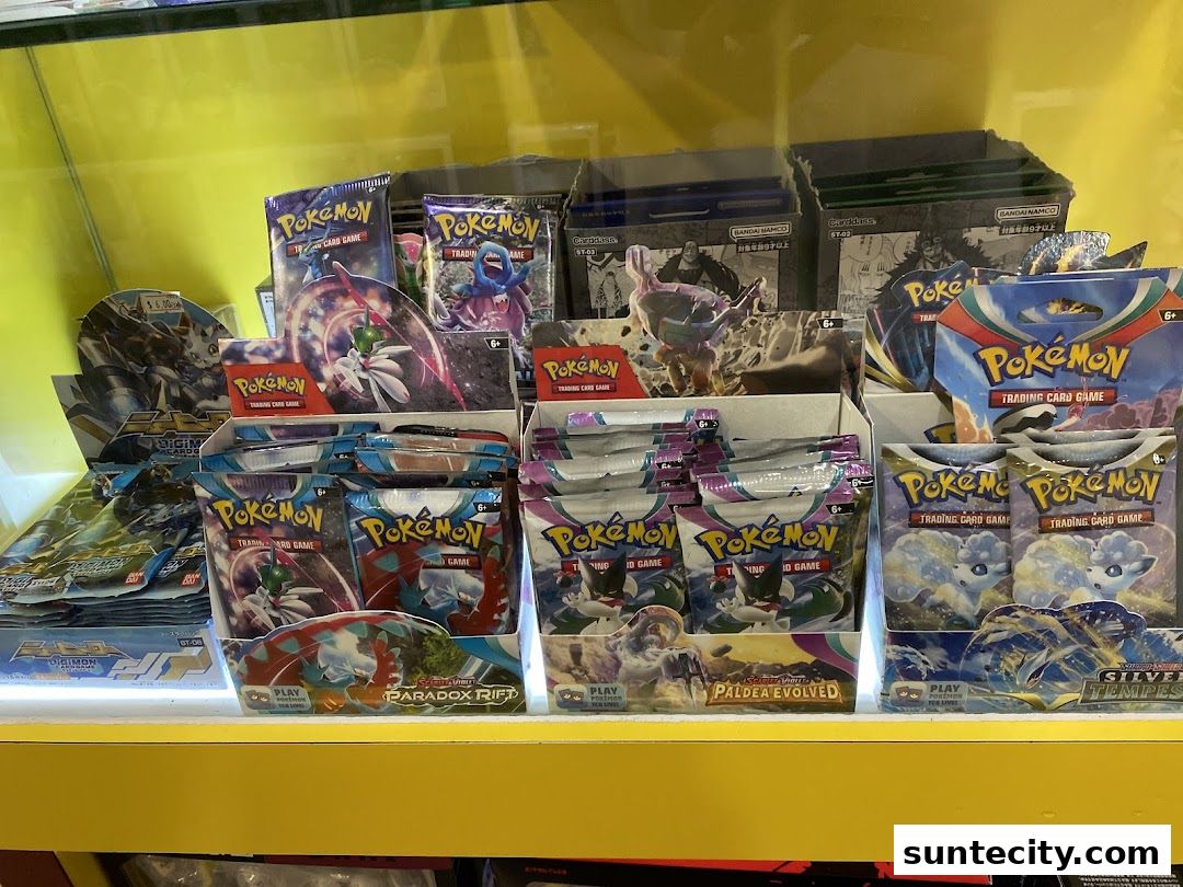 A display shelf filled with various Pokemon and Digimon trading card game booster packs.