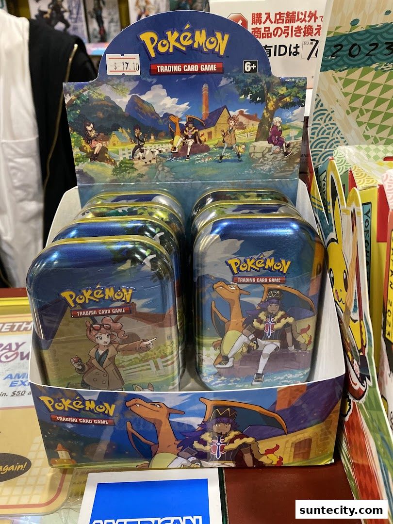 Display of Pokemon Trading Card Game tins featuring various characters and Pokemon.