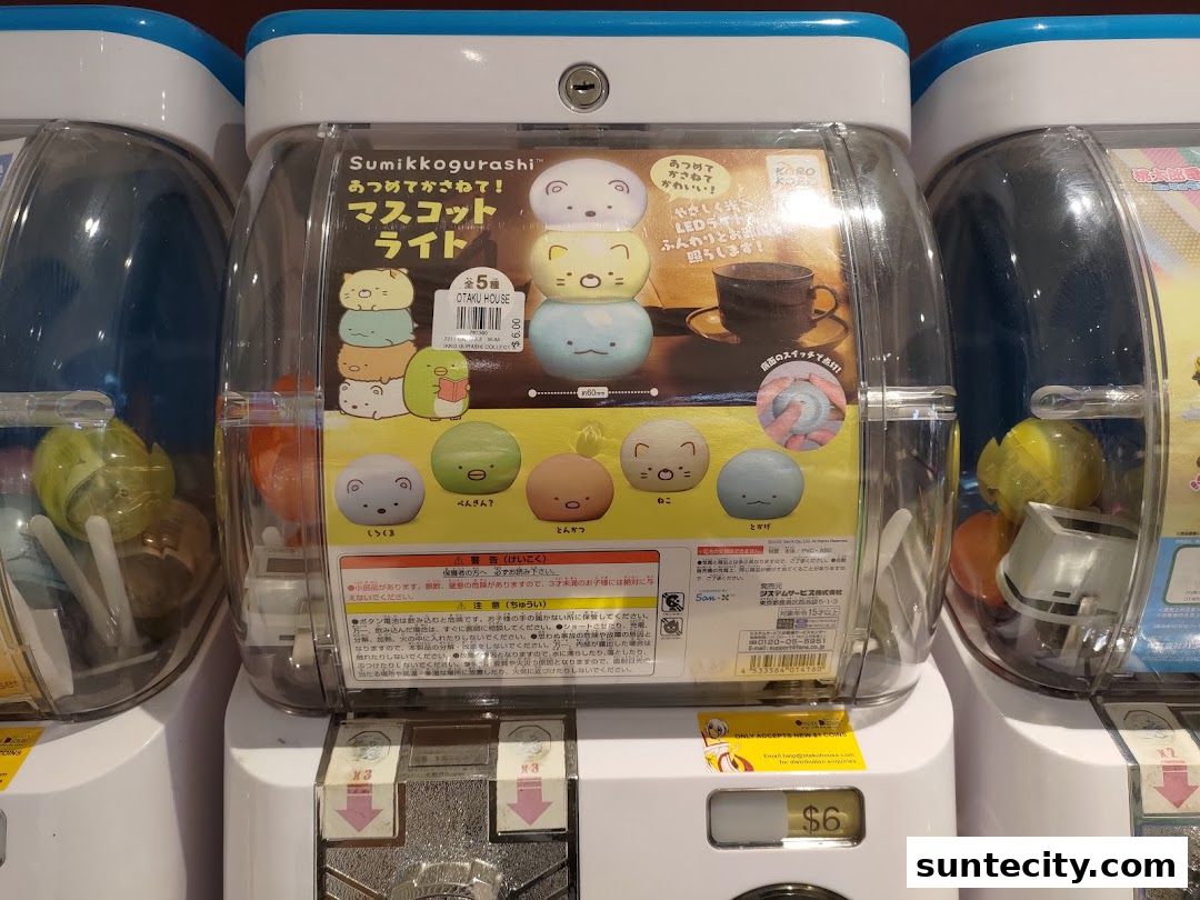 Gachapon machines featuring Sumikkogurashi mascot lights with various characters.