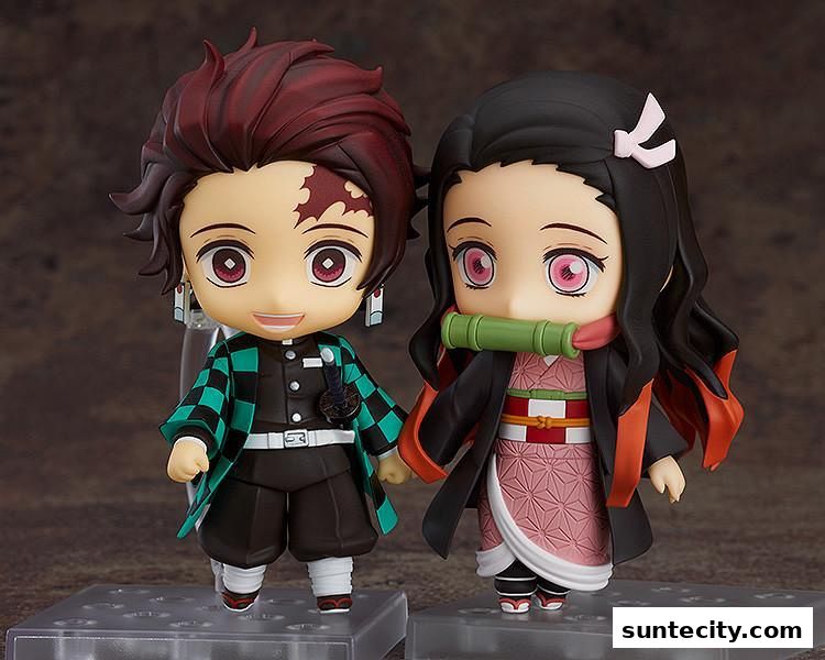 Two anime-style figures, a boy and a girl, are displayed on clear stands.