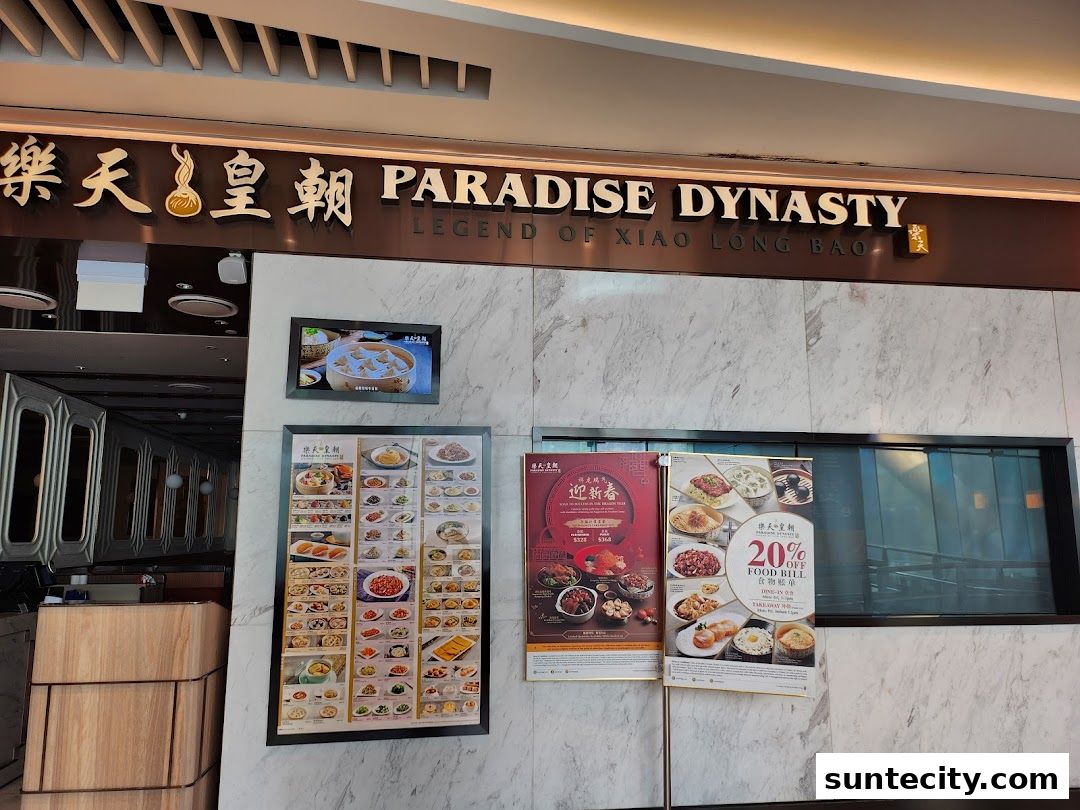 The exterior of Paradise Dynasty restaurant with its signage and displayed menus.